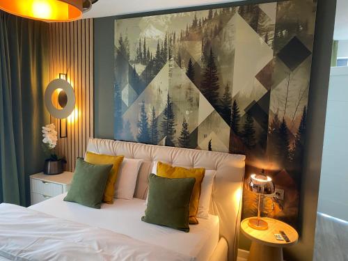 a bedroom with a bed with a painting on the wall at Solaris Zenith View in Buşteni