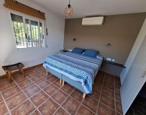 a bedroom with a bed with blue pillows on it at Finca Mirador in Macastre