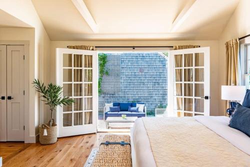 a bedroom with a bed and a sliding glass door at Luxurious Nantucket Getaway Heated Pool in Nantucket