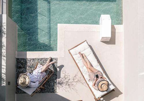 a person laying in a hammock next to a pool at Dia Viou Rene in Paradisos