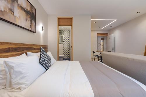 a bedroom with a large white bed in a room at Guadalupe Inn in Mexico City