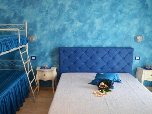 a child laying on a bed in a room with blue walls at B&B - TallyHo in Salve