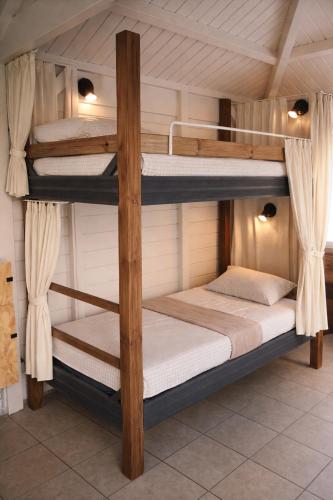 a bunk bed in a room with two bunk beds at Coco'Living - Gîtes de standing partagés in Gourbeyre