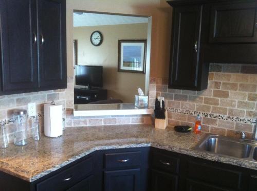 a kitchen counter with a sink and a mirror at Manley Lodge in Locust Grove