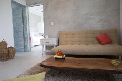 a living room with a couch and a coffee table at Villas H2O in Tulum