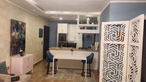 a kitchen with a sink and a table in a room at Maison Verde Madinaty in Cairo