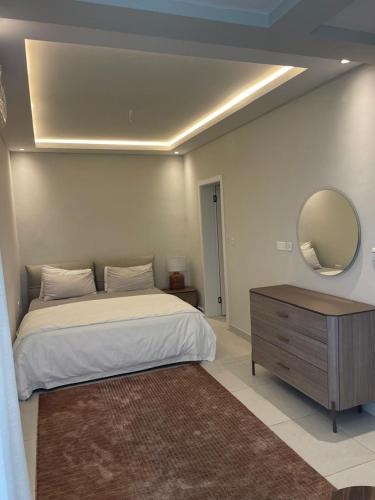 a bedroom with a bed and a mirror and a dresser at Tanji Cliffs in Tanji