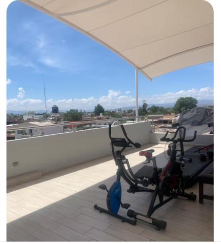 two exercise bikes sitting on top of a roof at Complejo Las Flores departamento 3 in Durango