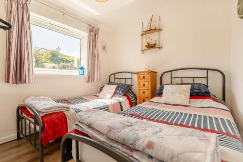two twin beds in a room with a window at 2 Bed in Brixham oc-57244 in Brixham