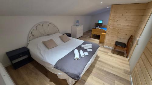 a bedroom with a bed with two pillows on it at Le Chalet de Merlimont in Merlimont