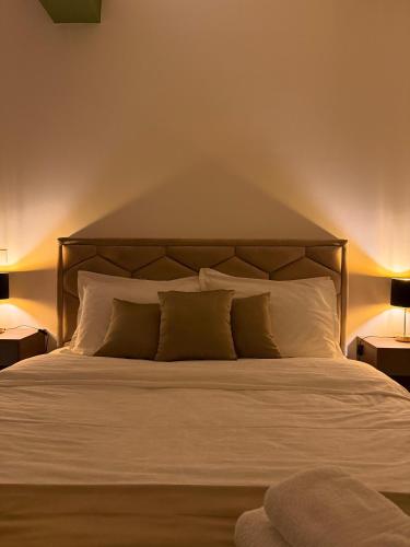 a bedroom with a large bed with white sheets and pillows at ENA Lux in Novi Pazar