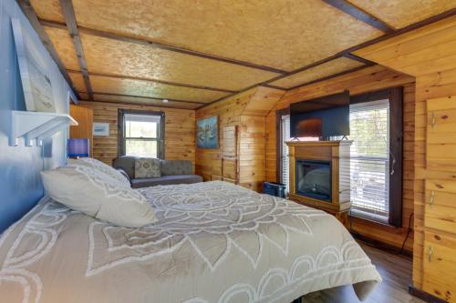 a bedroom with a large bed and a fireplace at Rustic Poland Vacation Rental w/ Waterfront Deck! in Poland