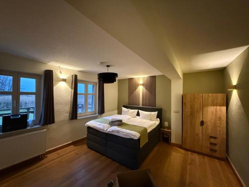 a bedroom with a bed and a tv in it at Forsthaus Boberow in Rheinsberg