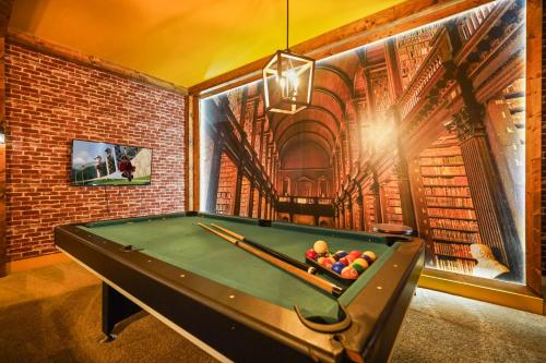 a billiard table in a room with a brick wall at Resort Villa 15BR Veranda Palms in Kissimmee