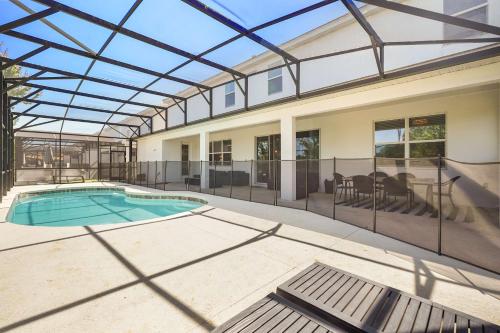 a house with a swimming pool with a glass ceiling at Resort Villa 15BR Veranda Palms in Kissimmee