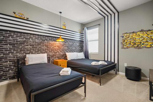 a bedroom with two beds and a brick wall at Resort Villa 15BR Veranda Palms in Kissimmee