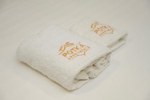 a pile of towels with the words happy new year at Potka Apartments Tirane in Yzberishti