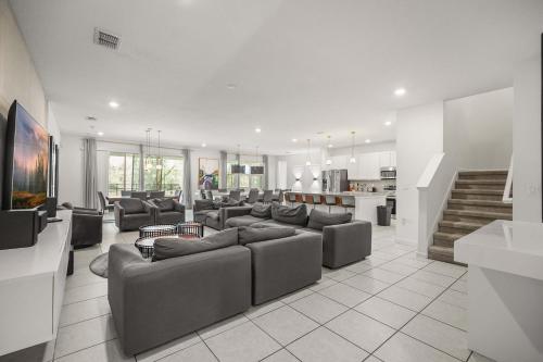 a large living room with couches and a kitchen at Resort Villa 15BR Veranda Palms in Kissimmee