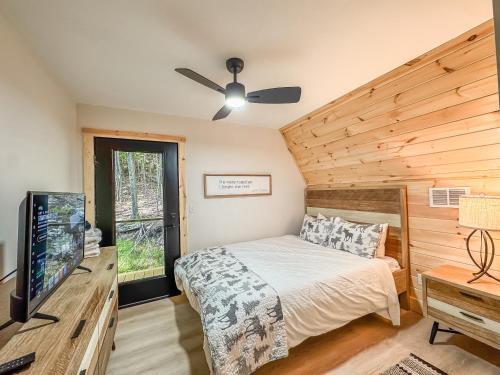 a bedroom with a bed and a flat screen tv at Stunning New Construction Modern Beautiful in McHenry