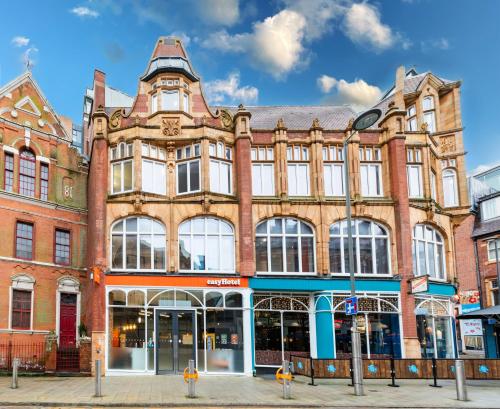 a large brick building on the corner of a street at easyHotel Birmingham in Birmingham