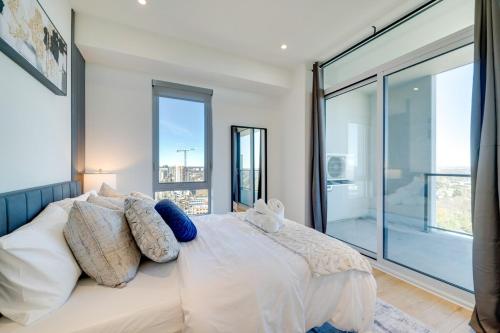 a bedroom with a bed with a large window at Stylish Open Concept Suite in Central KW in Kitchener
