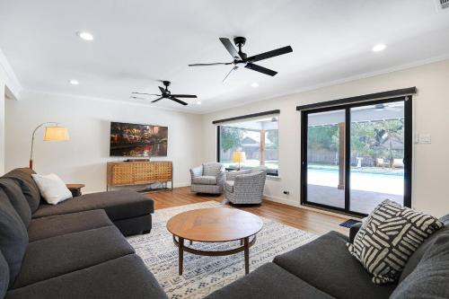 a living room with two couches and a table at Pool Home Nr DT River Walk Alamo WiFi Yard in San Antonio