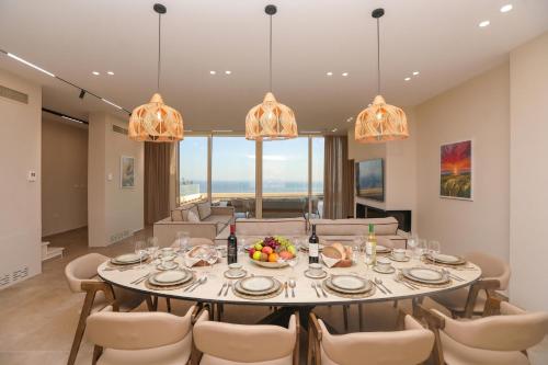 a dining room with a large table and chairs at Luxury Pool Villa Palasea With Panoramic Sea View in Vlorë