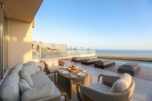a living room with couches and a view of the ocean at Luxury Pool Villa Palasea With Panoramic Sea View in Vlorë