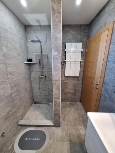 a bathroom with a shower with a glass door at Митровилица - Mitrovilica in Mitrovac