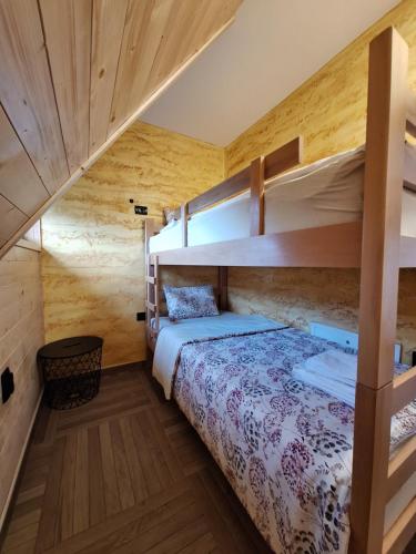 a bedroom with two bunk beds in a cabin at Митровилица - Mitrovilica in Mitrovac