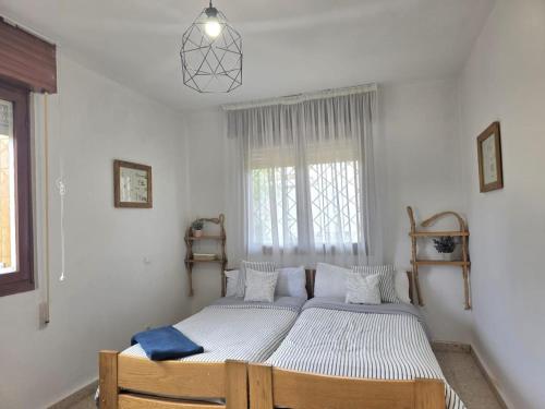 a bedroom with two beds in it with a window at Apartamento El Hayedo 20808 in Argoños