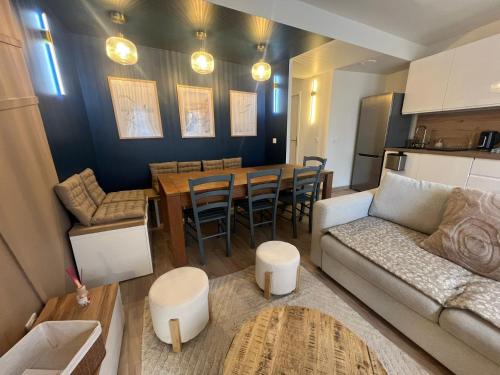 a living room with a couch and a table at Les Trois Mouettes - Grand appartement familial in Saint-Brieuc