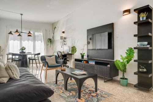 a living room with a couch and a tv at Casa Piccioni by Otium in San Juan