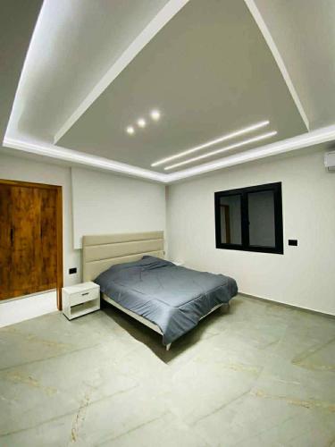 a bedroom with a bed and a flat screen tv at Villa SAM in Fafou