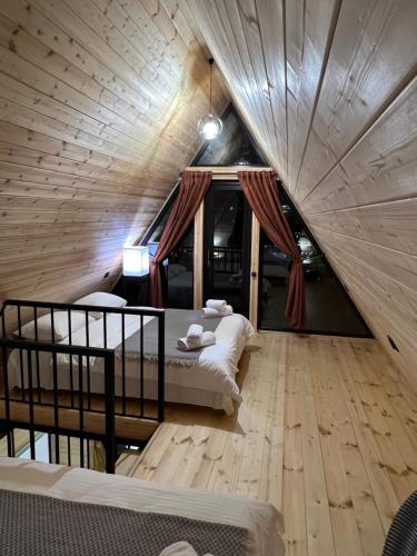 a bedroom with two beds in a large room at LizMari in (( Gergeti ))