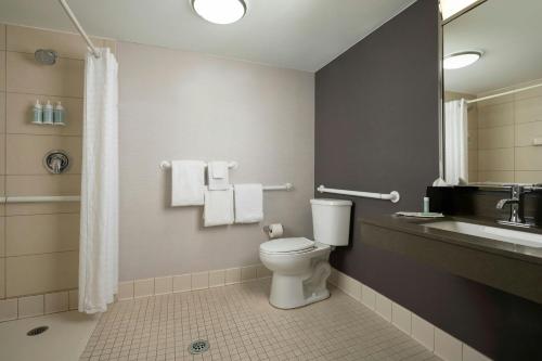 a bathroom with a toilet and a sink at Courtyard by Marriott Albuquerque Airport in Albuquerque
