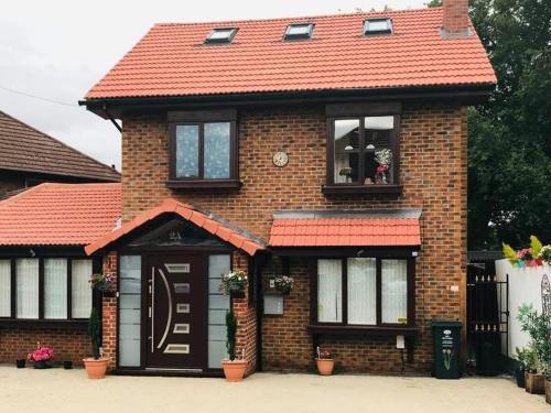 a brick house with a red roof at Read Oak Lodge - Spring Offer - Free Parking - Kitchen Laundry Facility - Near PRUH - Orpington - 20 Mins from London Bridge in Farnborough