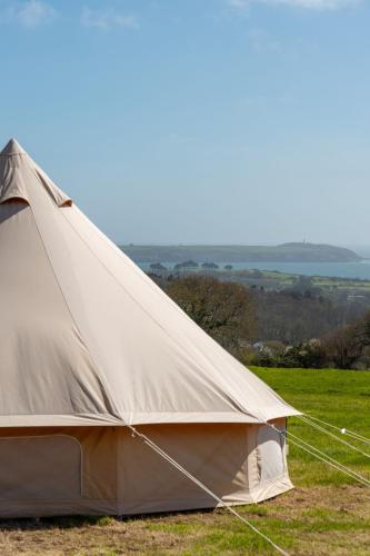 a canvas tent in a field of grass at Furnished Bell Tent 3 in Carlyon Bay