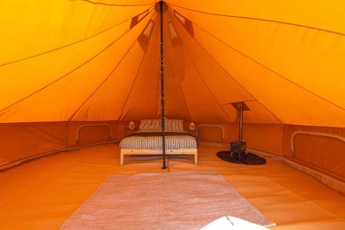 a room with a swing in a tent at Furnished Bell Tent 3 in Carlyon Bay