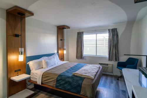 a hotel room with a bed and a window at Central Phoenix Hotel in Phoenix