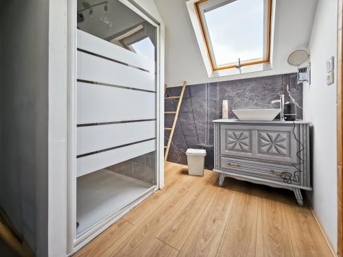 a bathroom with a sink and a mirror at La Maison des Jeux in Saint-Maur