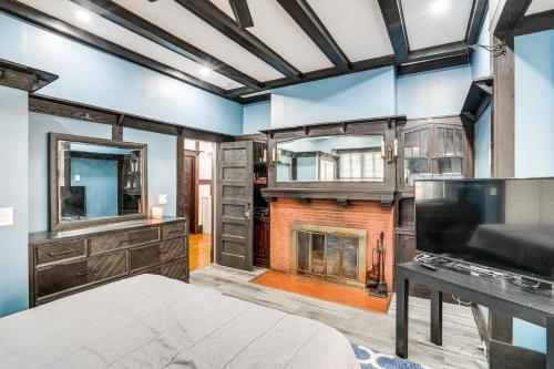 a bedroom with a fireplace and blue walls at Walkable Schenectady Getaway: 2-Unit Campus Hub in Schenectady