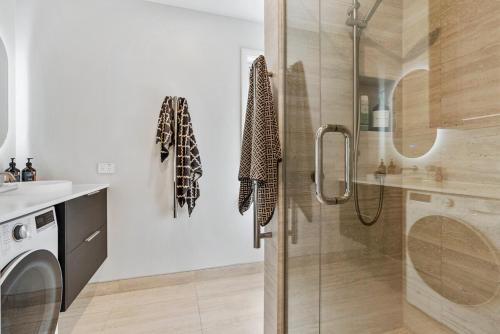 a bathroom with a shower with a glass door at Renovation, location, relaxation in Twizel