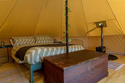 a room with a bed in a tent at Boscoppa Farm-Furnished Bell Tent 4 in St Austell