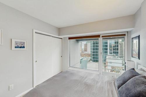 a bedroom with a bed and a large window at My Place at Pike Place in Seattle