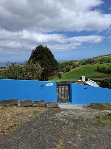 a blue wall with a gate on a hill at Home Near the Clouds - Refúgio in Nordeste