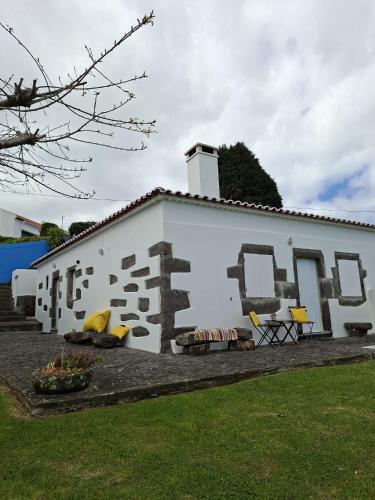 a white building with a mural on the side of it at Home Near the Clouds - Refúgio in Nordeste