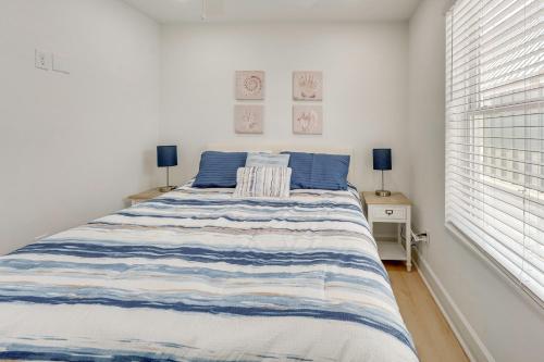 a bedroom with a bed with a blue and white striped blanket at Brand New Home in Steinhatchee with Rooftop Deck! in Jena