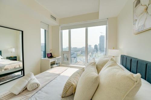 a bedroom with a bed with a large window at Stylish Open Concept Condo with Gym in Kitchener