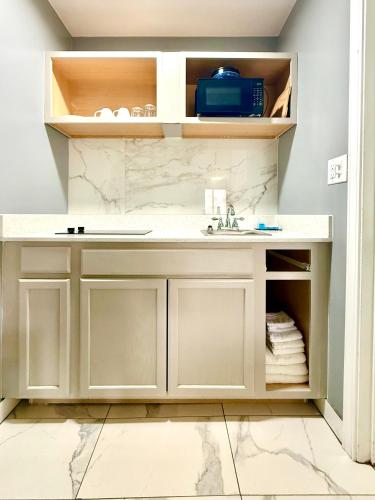a bathroom with a sink and a counter at Americas Best Value Inn Suites & Studios Blytheville by Sonesta in Blytheville